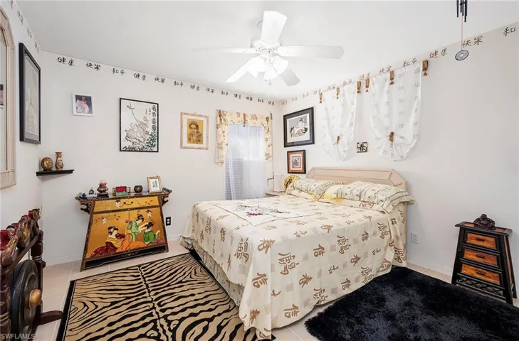 Bedroom featuring light tile patterned floors and ceiling fan