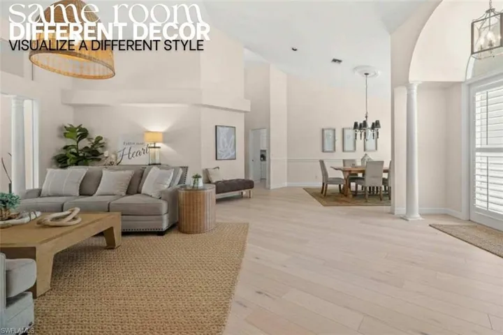 Living area featuring ornate columns, a chandelier, light wood finished floors, high vaulted ceiling, and arched walkways