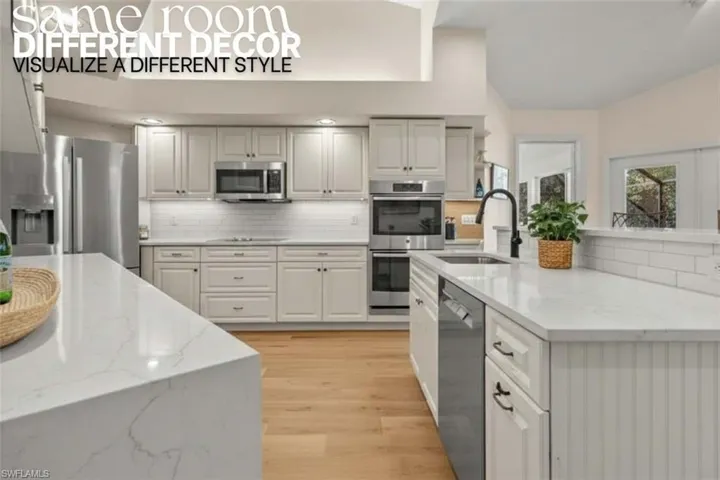 Kitchen with light stone countertops, appliances with stainless steel finishes, tasteful backsplash, and light wood-style flooring