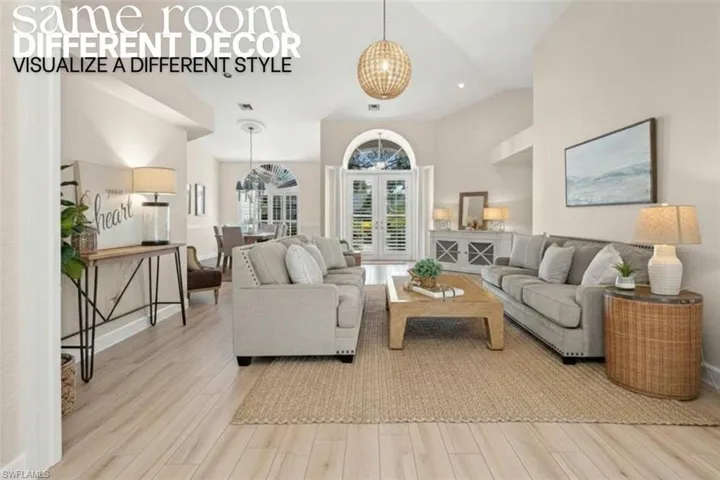 Living room featuring light wood-style flooring and high vaulted ceiling