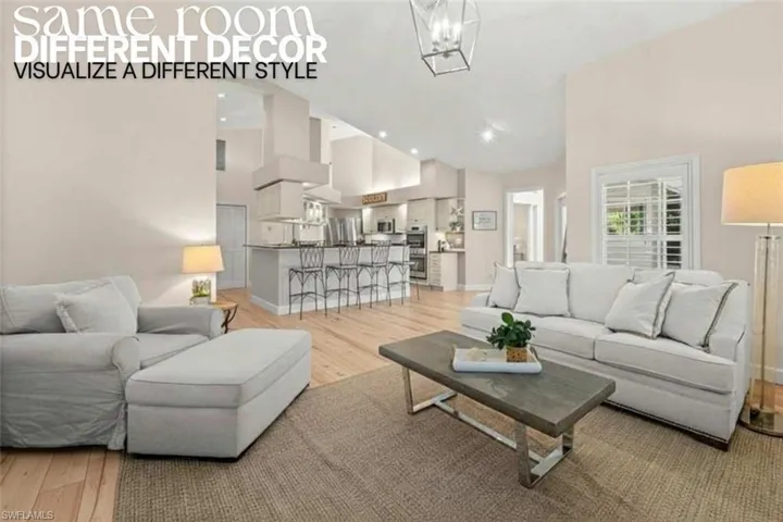 Living area with high vaulted ceiling, light wood-style floors, a chandelier, and recessed lighting