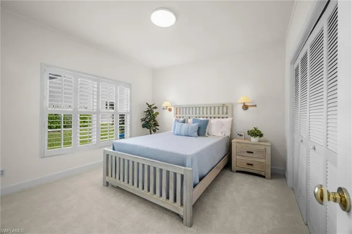 Bedroom with ornamental molding, a closet, and carpet floors