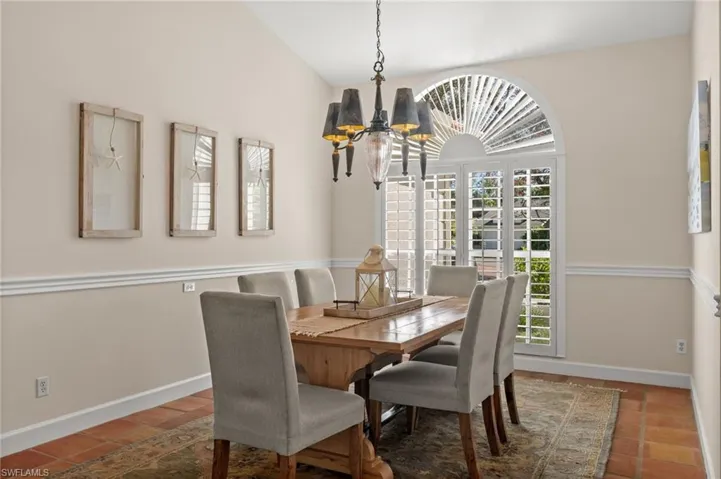 Dining space with a chandelier and lofted ceiling