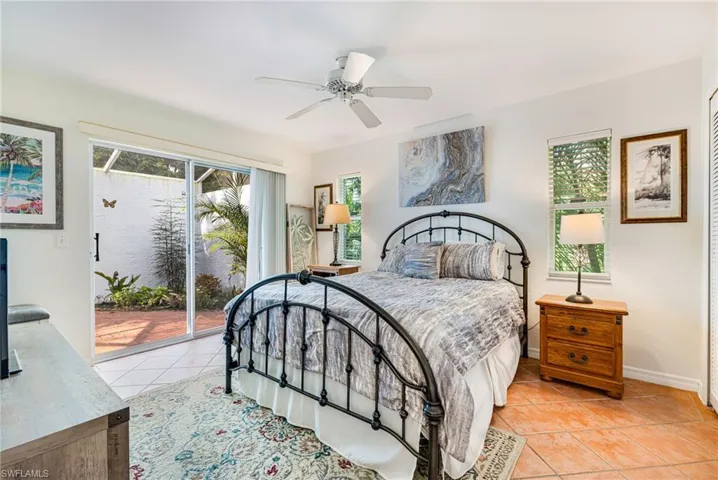 Bedroom with ceiling fan, access to outside, light tile patterned floors, and a closet