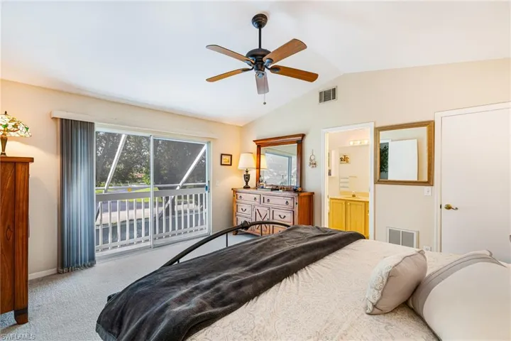 Bedroom featuring lofted ceiling, light carpet, access to exterior, and ceiling fan