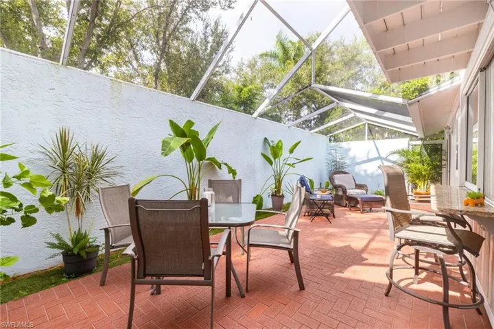 View of patio / terrace with a sunroom, a lanai, and outdoor dining space