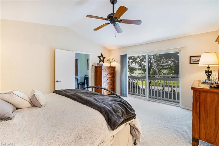 Bedroom with carpet flooring, access to exterior, lofted ceiling, and a ceiling fan