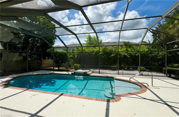 View of pool with a lanai, a patio, and pool water feature