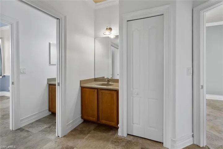 Bathroom featuring crown molding and vanity