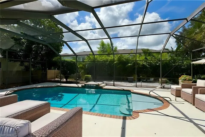 VIRTUAL STAGING  View of swimming pool featuring glass enclosure and a patio area