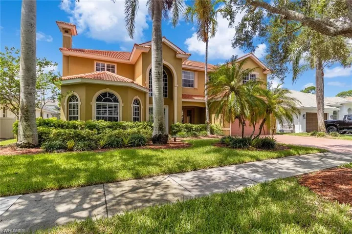 Mediterranean / spanish-style home featuring a garage and a front lawn