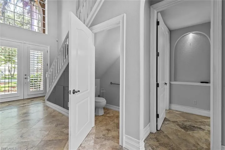 Bathroom featuring french doors and toilet