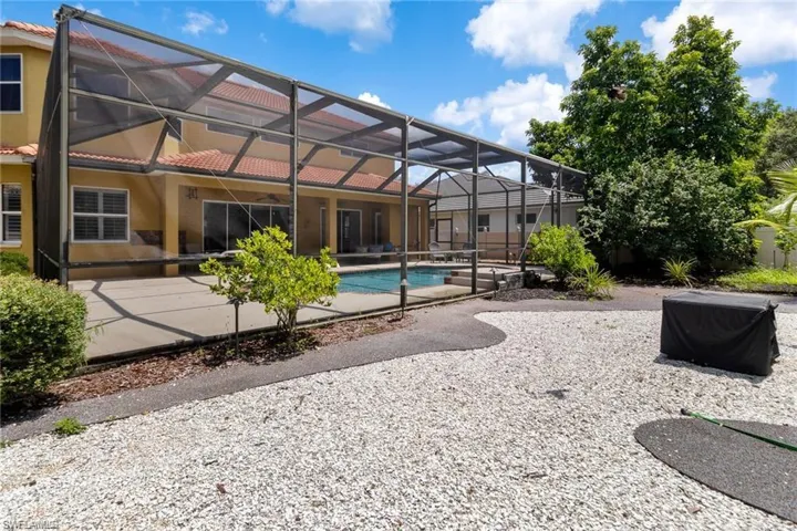 Back of house featuring a lanai and a patio