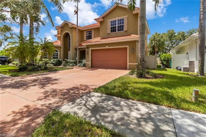 Mediterranean / spanish-style home featuring a garage and a front lawn
