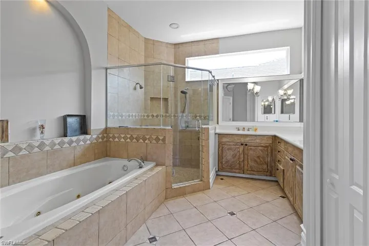 Bathroom with vanity, independent shower and bath, and tile patterned floors