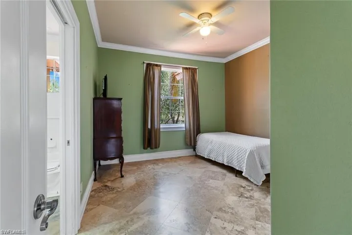 Bedroom featuring ceiling fan and crown molding