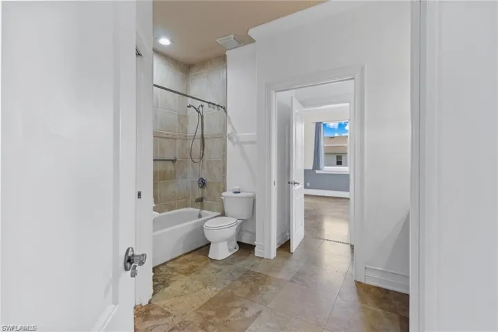 Bathroom featuring toilet and tiled shower / bath