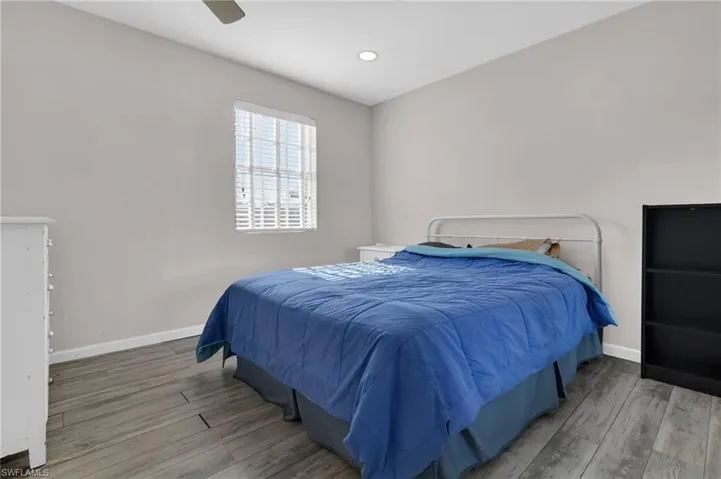 Bedroom featuring recessed lighting,  finished floors, and baseboards