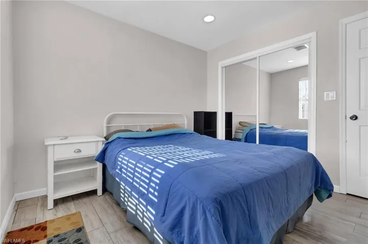 Bedroom with recessed lighting, floors, visible vents, a closet, and baseboards