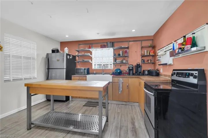 island, a sink, and recessed lighting