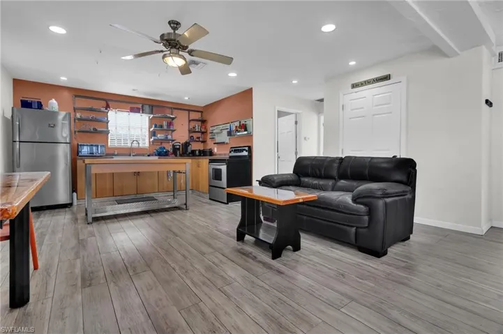 Living area with light  flooring, baseboards, visible vents, recessed lighting, and a ceiling fan