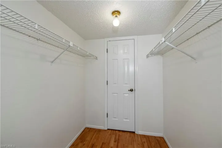 Primary bedroom closet walk in with extra storage closet