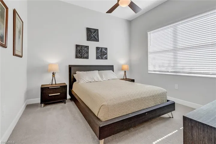 Bedroom featuring ceiling fan and light carpet
