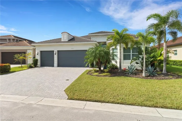 View of front of house with a front yard and a garage
