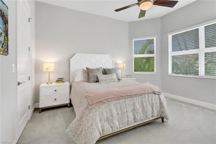 Carpeted bedroom featuring ceiling fan