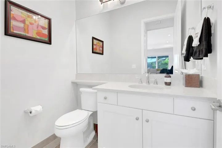 Bathroom with vanity, toilet, and tile patterned flooring