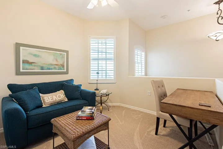 Carpeted home office with baseboards and ceiling fan