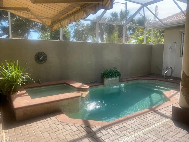 Pool area with water features and privacy wall