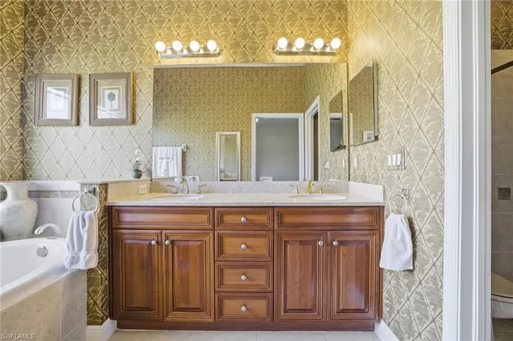 Primary Bathroom with soaking tub, dual sinks, cabinetry