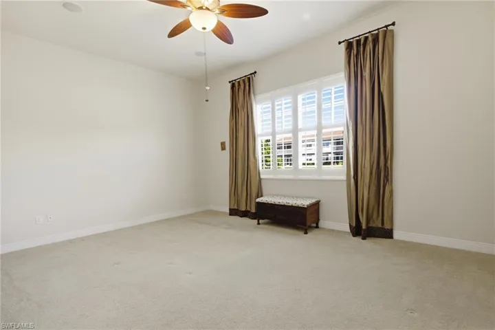 Primary Bedroom with windows overlooking the lake