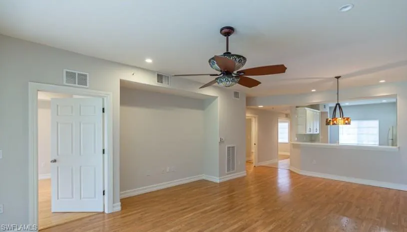 Unfurnished living room with baseboards, recessed lighting, visible vents, and light wood-type flooring