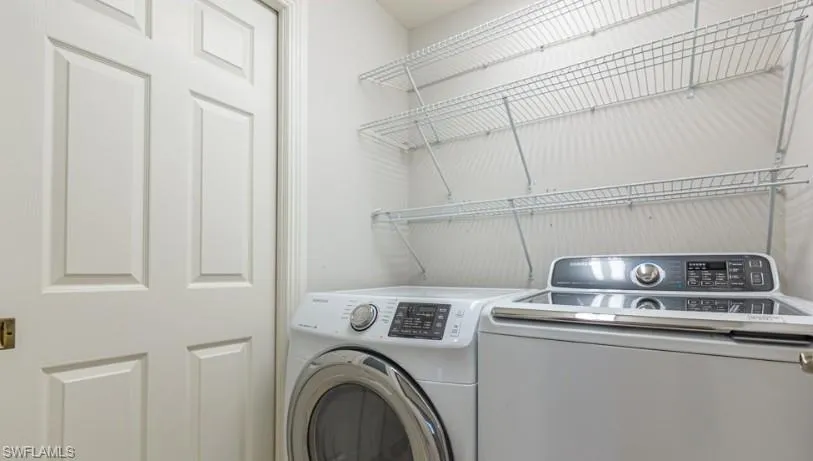 Washroom featuring laundry area and separate washer and dryer