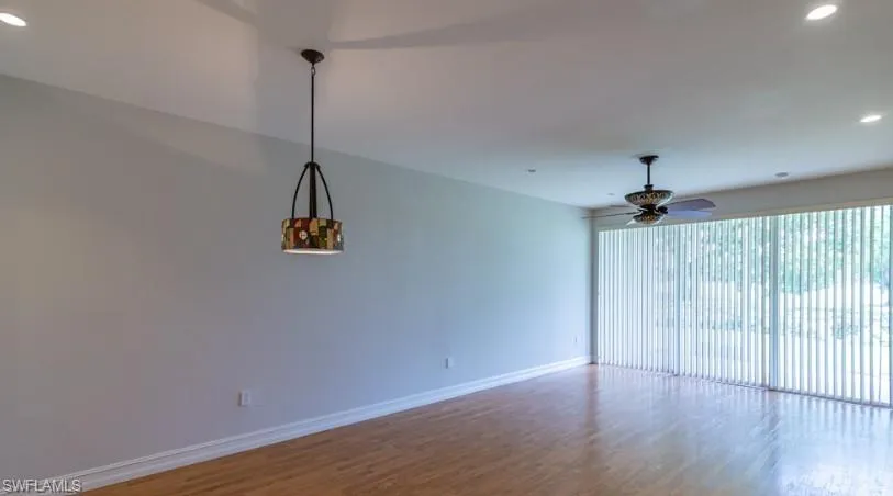 Empty room featuring recessed lighting, wood finished floors, baseboards, and ceiling fan