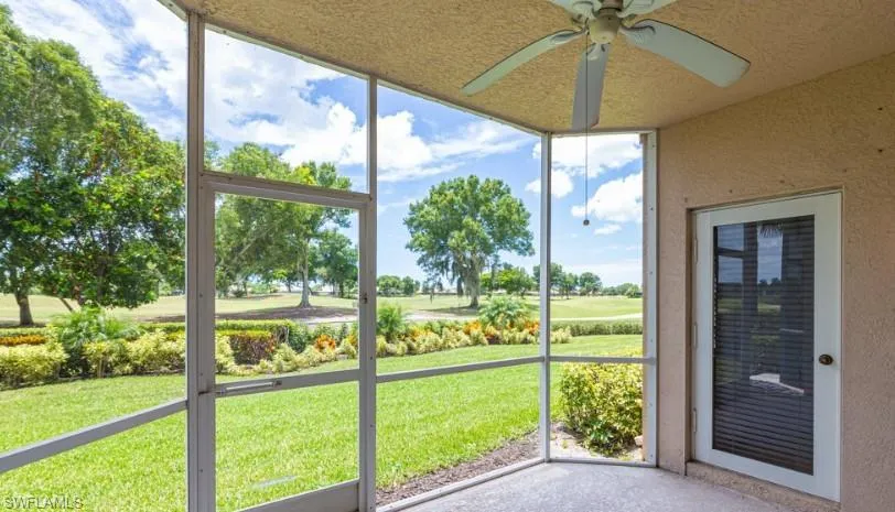 Unfurnished sunroom featuring a ceiling fan