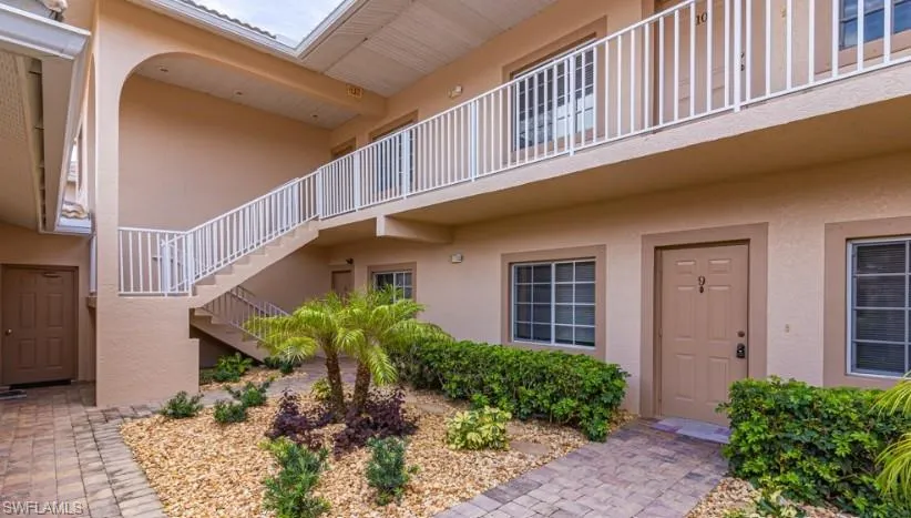 Doorway to property featuring stucco siding