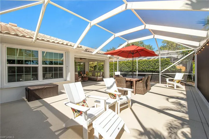 Covered lanai seating area with fan and additional extended lanai for  your entertainment included Grill and fridge Multi seating areas with lakefront view