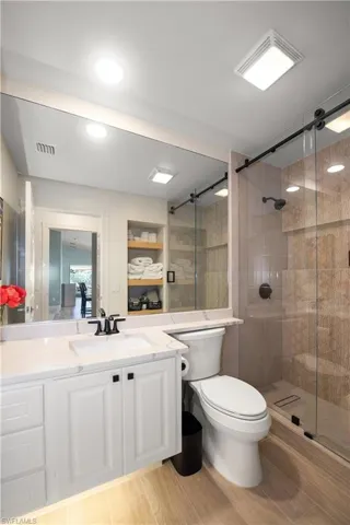 Guest Bath remodel new tiles, closet with wooden shelves, sink faucet.