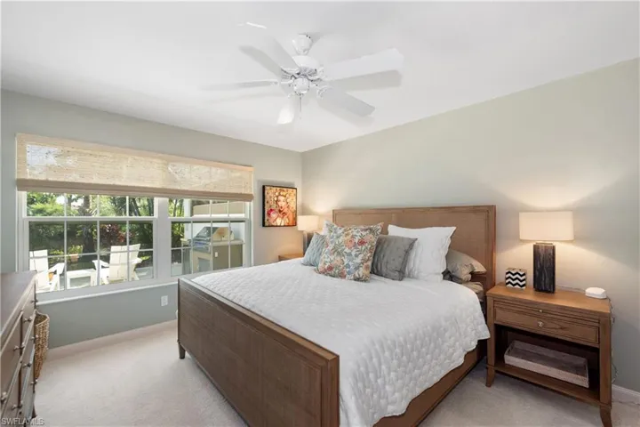 Main master bedroom overlooking the lake views, Hunter Douglas bamboo shades calling fan