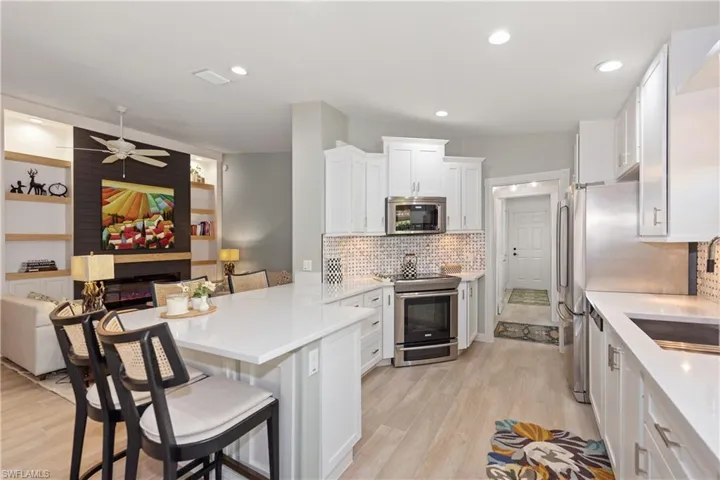 Kitchen with breakfast bar to family room, living rm screened covered lanai and extenderblanai all in one open floor plan
