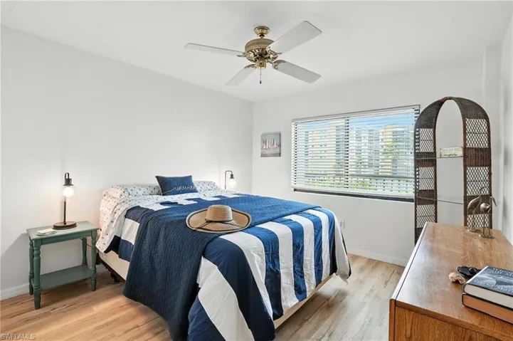 Bedroom with light wood finished floors and a ceiling fan