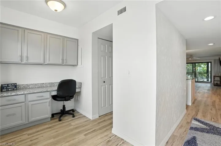 Home office with built in desk, light wood-type flooring, recessed lighting, and ceiling fan