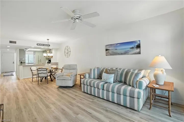 Living area featuring light wood-style floors and a ceiling fan