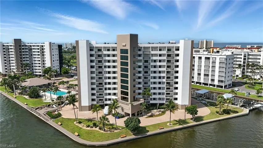 View of apartment building / complex featuring a water view