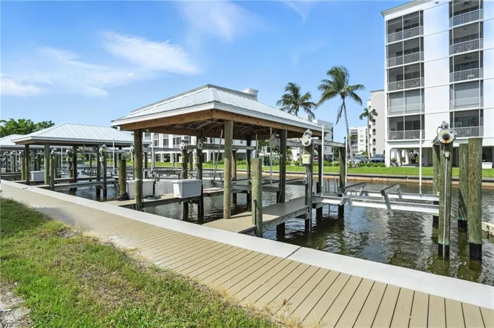 Dock area featuring boat lift and a water view