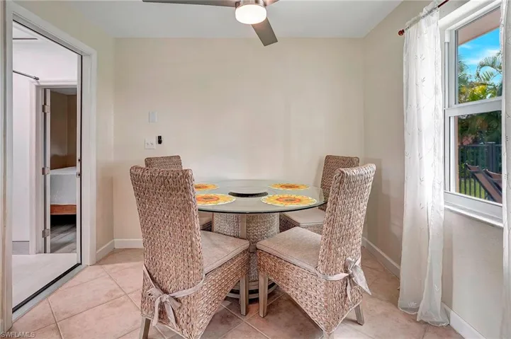 Dining space with light tile patterned flooring and ceiling fan