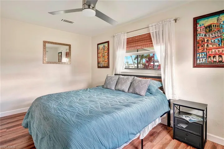 Bedroom featuring wood-type flooring and ceiling fan